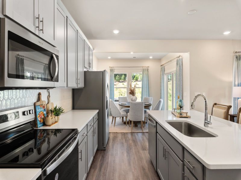 The well-appointed kitchen with a large island generous pantry makes meal prep a breeze. The well-appointed kitchen with a large island generous pantry makes meal prep a breeze.