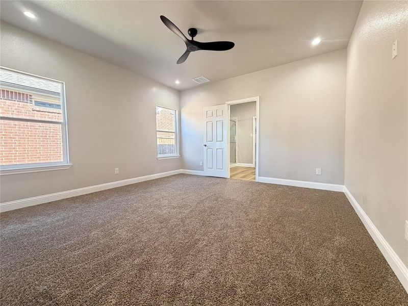 Unfurnished bedroom with carpet floors, a ceiling fan, and recessed lighting