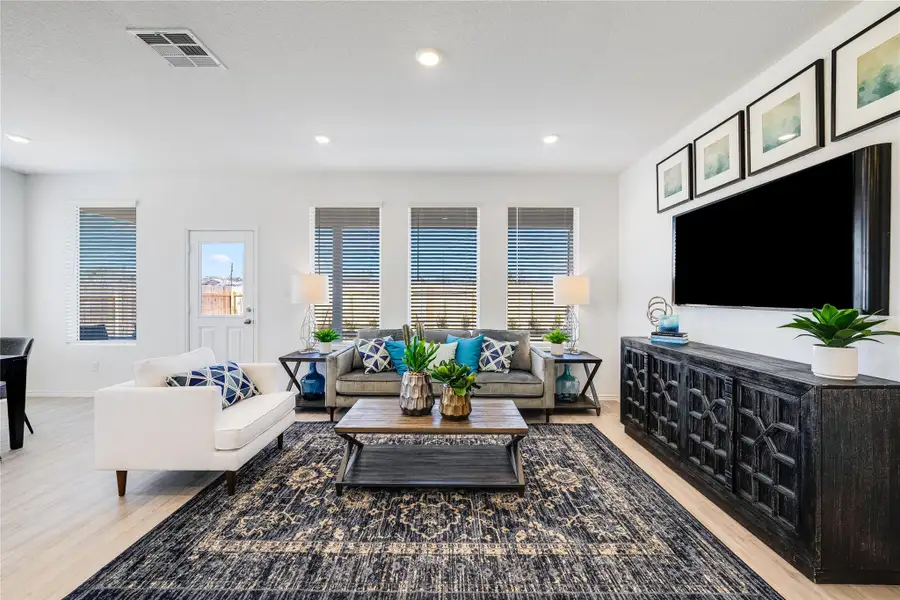 Living room featuring light wood finished floors and recessed lighting