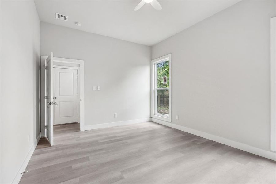 Empty room featuring ceiling fan and light hardwood / wood-style flooring