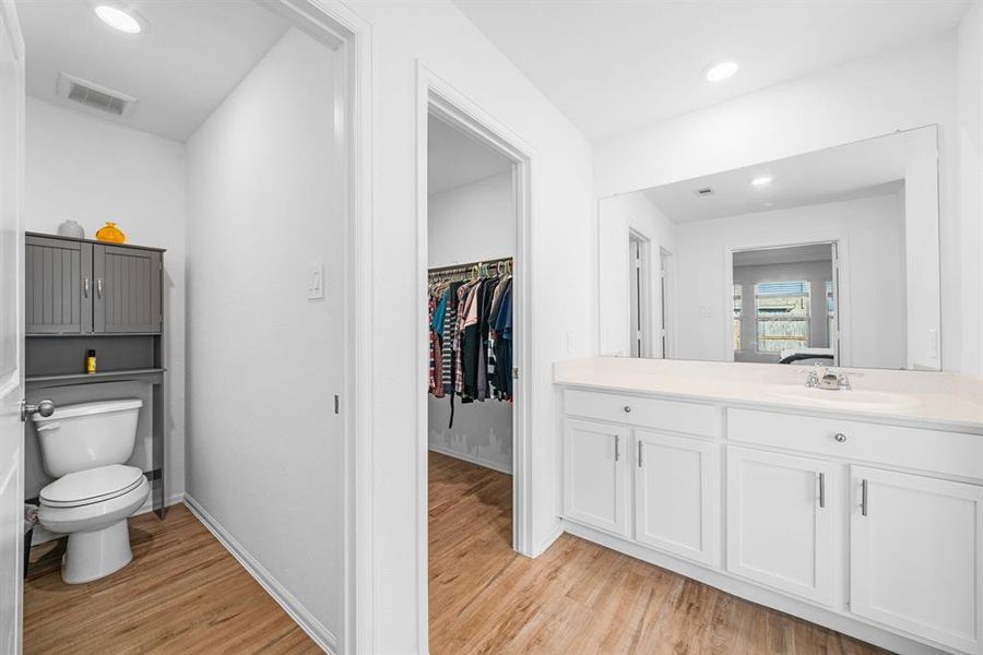 Primary bathroom with view of 1 of the 2 walk-in closets