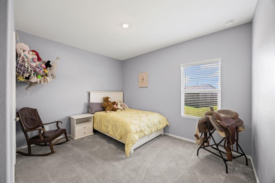 Bedroom 4 with light colored carpet and baseboards Bedroom 4 with light colored carpet and baseboards