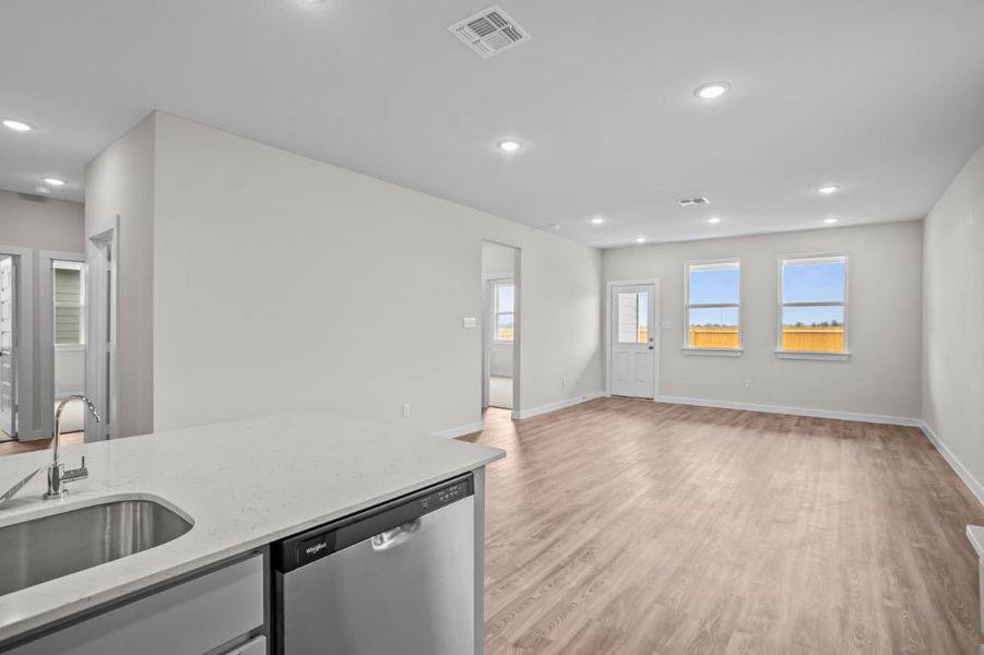 A kitchen with a wood floor.