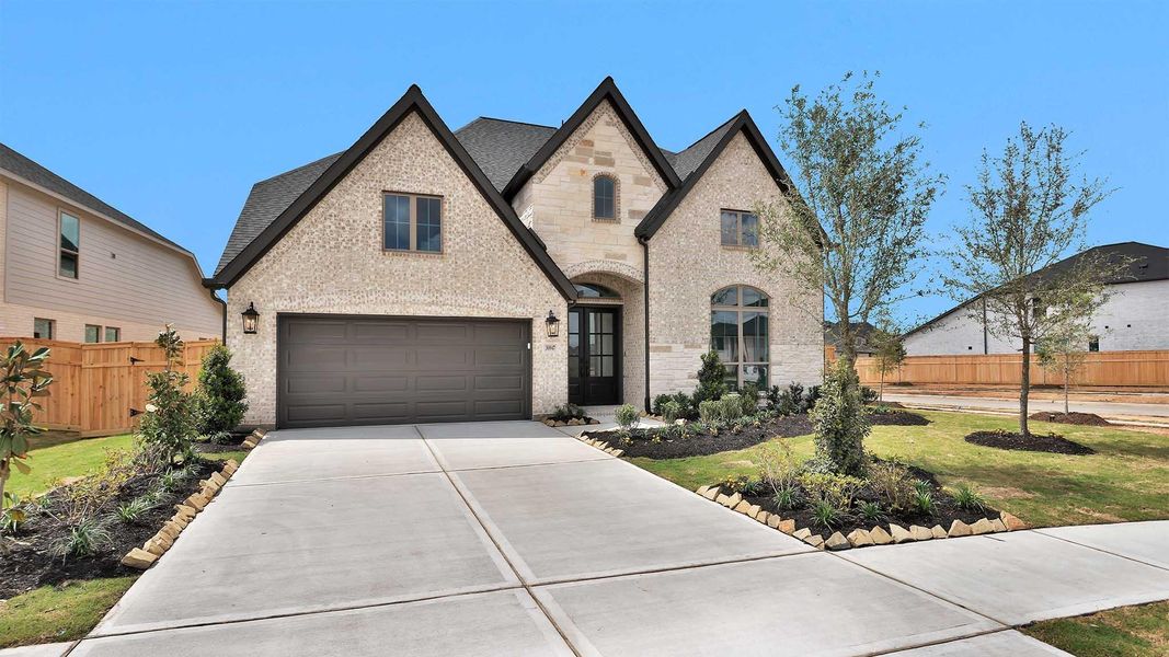 Front exterior of a new home in Cross Creek West, Fulshear, TX, highlighting curb appeal (Image 2). Front exterior of a new home in Cross Creek West, Fulshear, TX, highlighting curb appeal (Image 2).