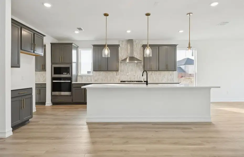 Spacious kitchen with eat-in bartop island *Model Representation*