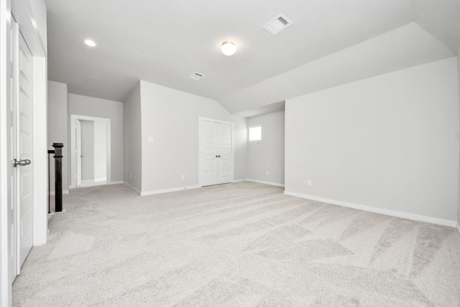 Ascend to relaxation in this fantastic game room! Ideal for both casual gatherings and adult gaming, it boasts plush carpet, lofty ceilings, custom paint, and ample windows for abundant natural light. Sample photo of completed home with similar floor plan. Actual colors and selections may vary.