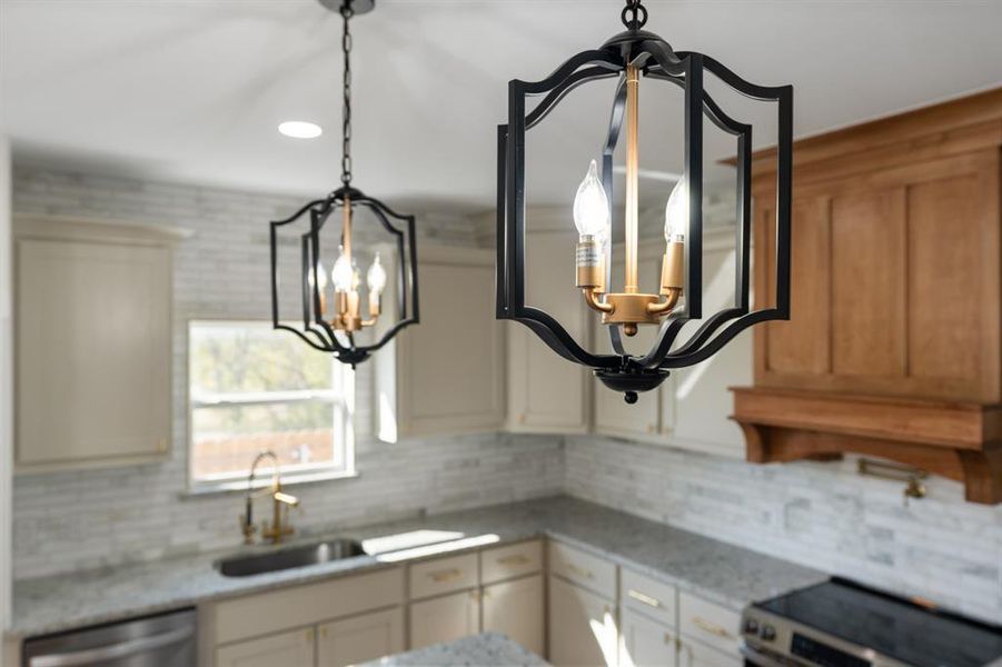 Kitchen with light stone counters, backsplash, appliances with stainless steel finishes, and recessed lighting Kitchen with light stone counters, backsplash, appliances with stainless steel finishes, and recessed lighting