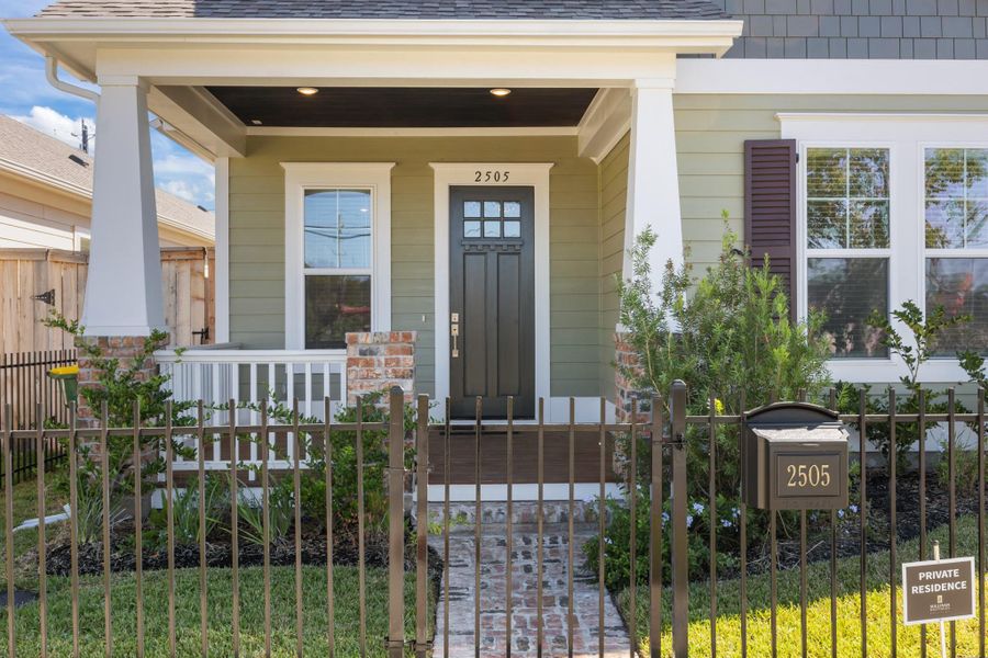 Cozy Front Porch and lucious landscaped yard