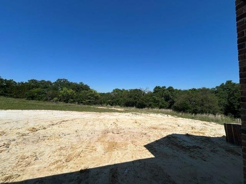 Generous lot featuring cleared ground and a natural treeline perimeter