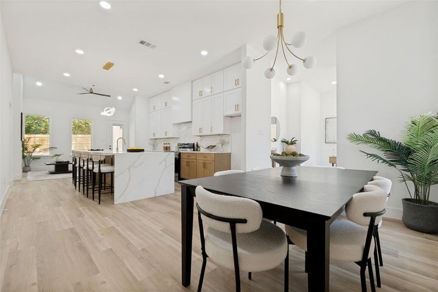 Open-concept living space featuring wood-finish flooring, recessed lighting, and a vaulted ceiling Open-concept living space featuring wood-finish flooring, recessed lighting, and a vaulted ceiling