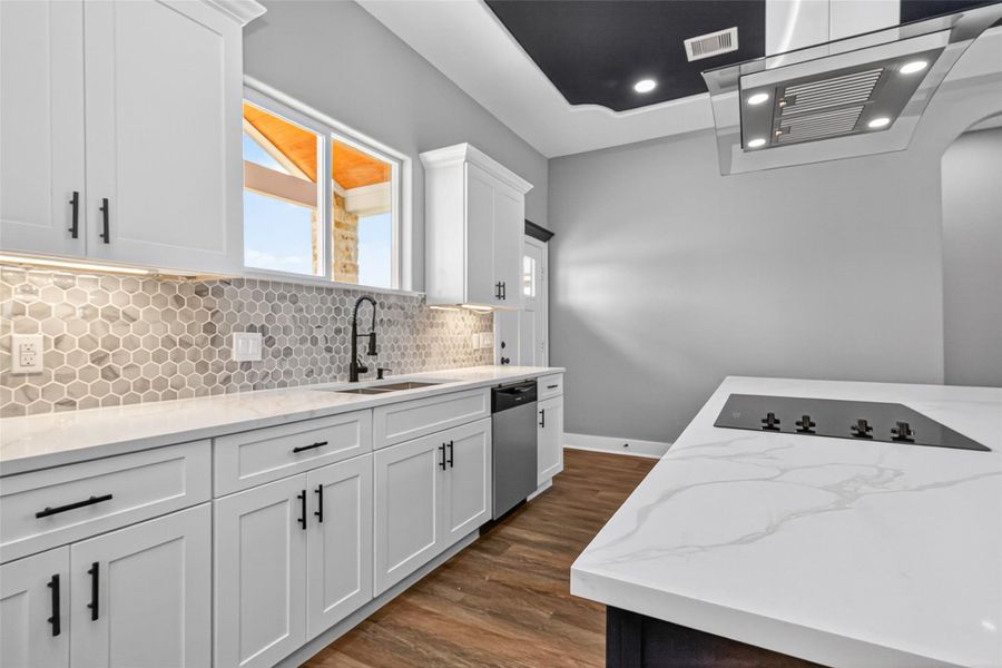 Kitchen offers generous workspace, custom cabinetry, and convenient access to the dining area. Kitchen offers generous workspace, custom cabinetry, and convenient access to the dining area.