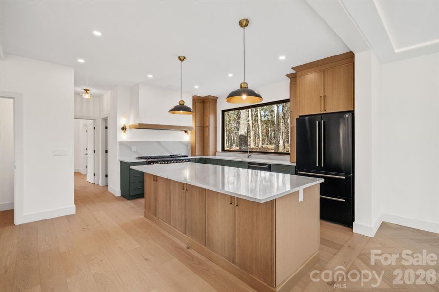 Designer kitchen with white oak and Astor green cabinetry in a contemporary slim shaker profile