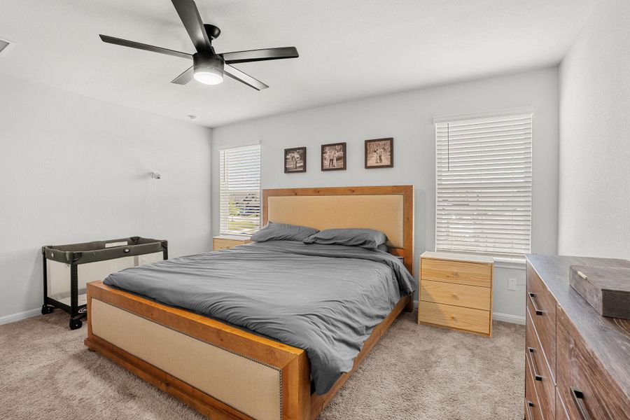 Well-lit sleeping quarters with a functional ceiling fan, offering a comfortable personal retreat.