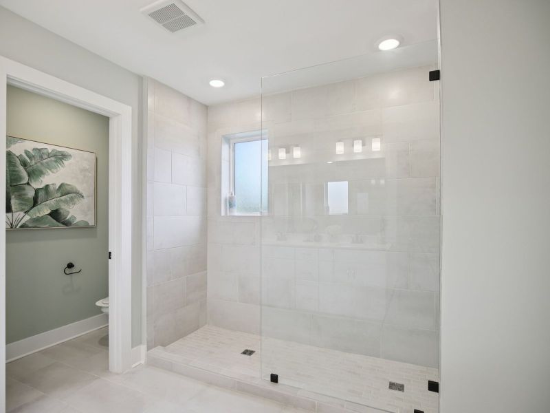 The primary bathroom offers a calming space to start and end your day.