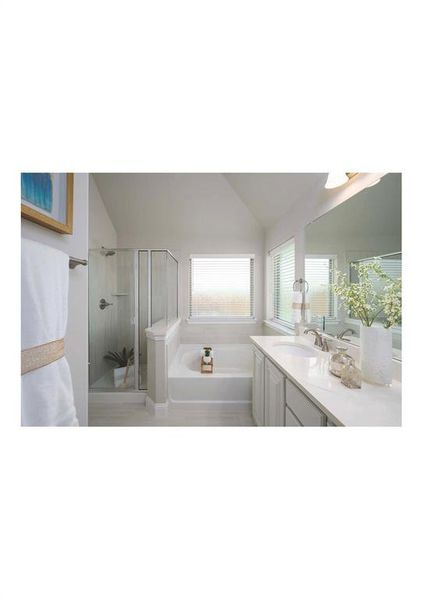 Bathroom with vanity, independent shower and bath, and lofted ceiling