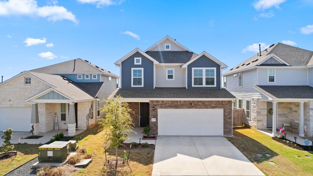 View of front of property with a porch, concrete driveway, a shingled roof, and an attached garage View of front of property with a porch, concrete driveway, a shingled roof, and an attached garage
