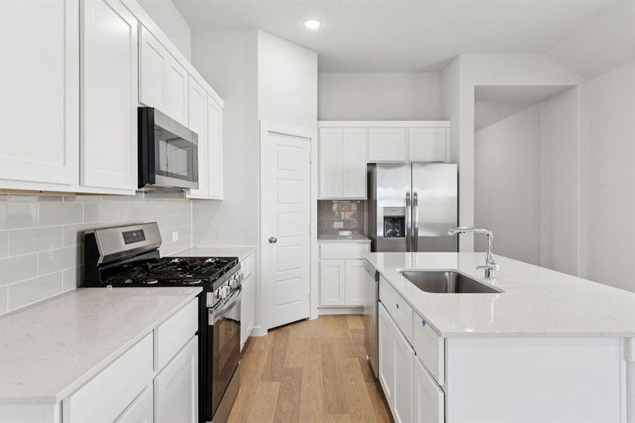 Kitchen in the Cedar home plan by Trophy Signature Homes – REPRESENTATIVE PHOTO