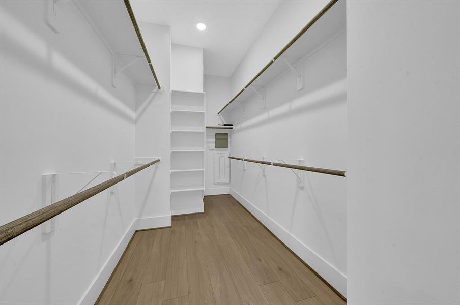 Spacious primary closet provides ample space for organizing your wardrobe. In addition, the closet is equipped with a network panel, providing a centralized location for managing your home's network and smart devices