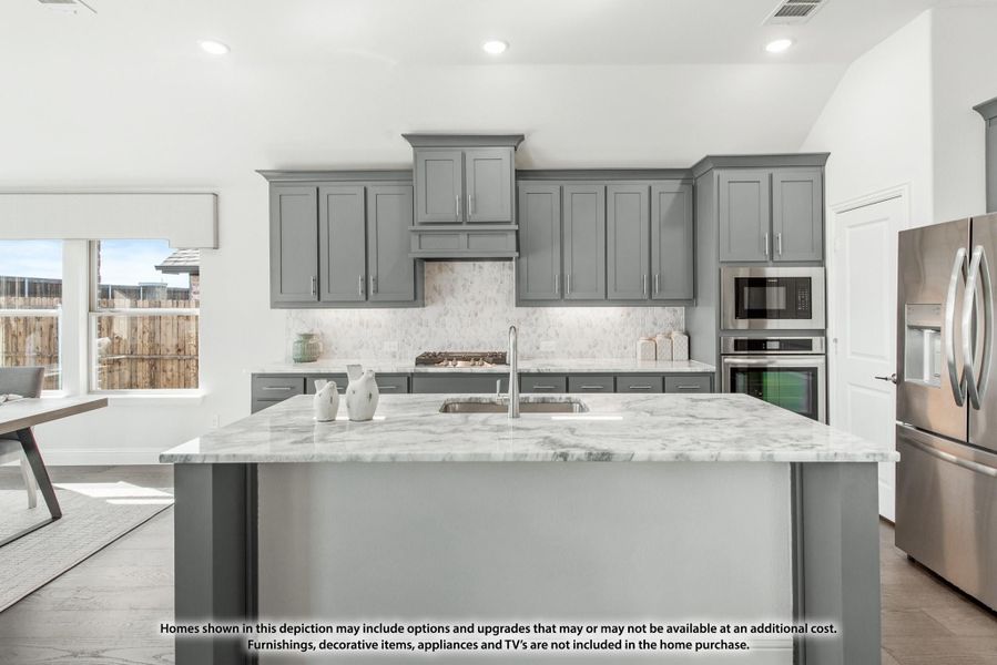 Kitchen with gray shaker cabinets, marble island with sink, tile backsplash, and stainless steel appliances Kitchen with gray shaker cabinets, marble island with sink, tile backsplash, and stainless steel appliances
