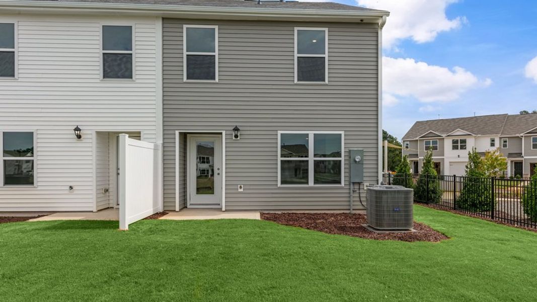 Exterior details and patio area of a home in The Townes at Hunter Hill, Rocky Mount (Image 24).