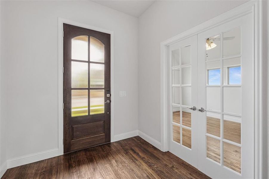 Entrance foyer featuring dark wood finished floors, a ceiling fan, and french doors