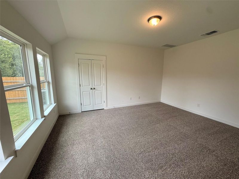 Carpeted spare room featuring baseboards Carpeted spare room featuring baseboards