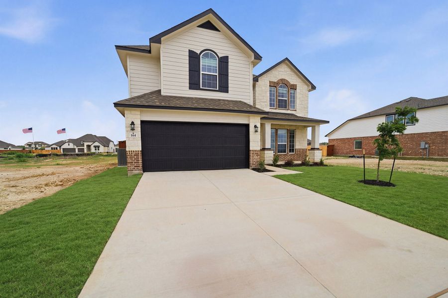 Front exterior of a new home in Megan's Landing, Castroville, TX, highlighting curb appeal (Image 19).