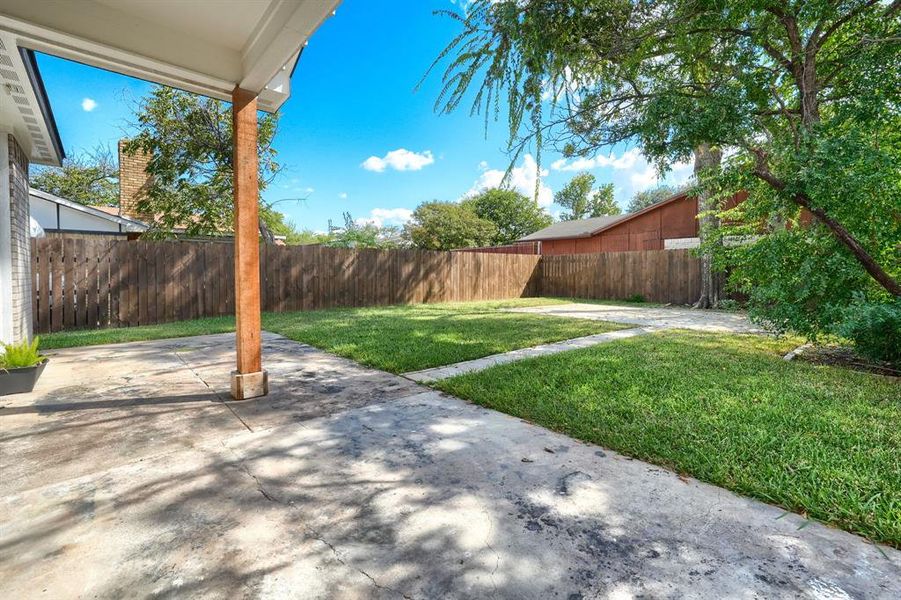 Backyard with large, covered slab and space for a fire pit area Backyard with large, covered slab and space for a fire pit area