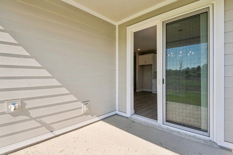 Covered back lanai with large sliding glass doors