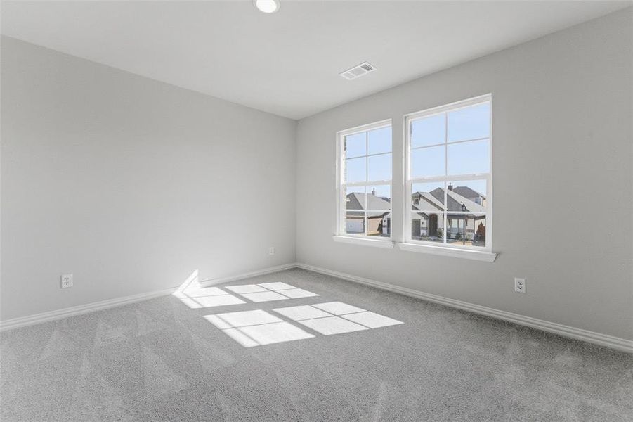 Unfurnished room featuring carpet floors and baseboards