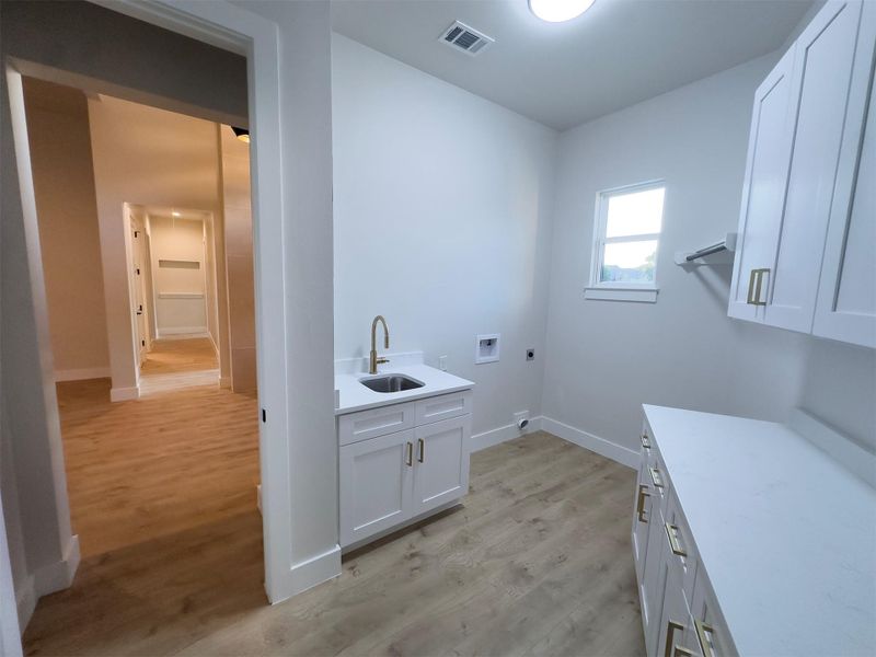 Functional workspace features durable solid surface countertops alongside custom cabinetry and resilient wood-look flooring. Functional workspace features durable solid surface countertops alongside custom cabinetry and resilient wood-look flooring.