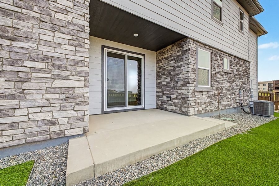 Exterior details and patio area of a home in Painted Prairie, Aurora (Image 13).