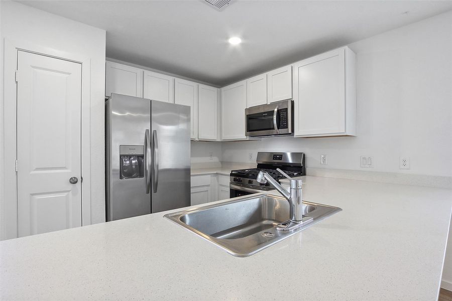 Gourmet Kitchen with Stainless Steel Appliances and Farm House Sink.