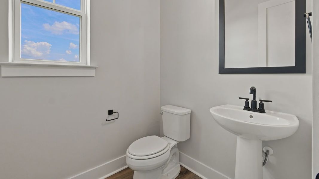 Classic half bathroom for downstairs area with side window.