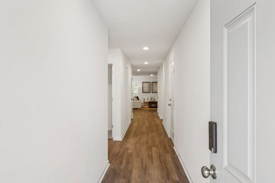 A hallway with white doors.