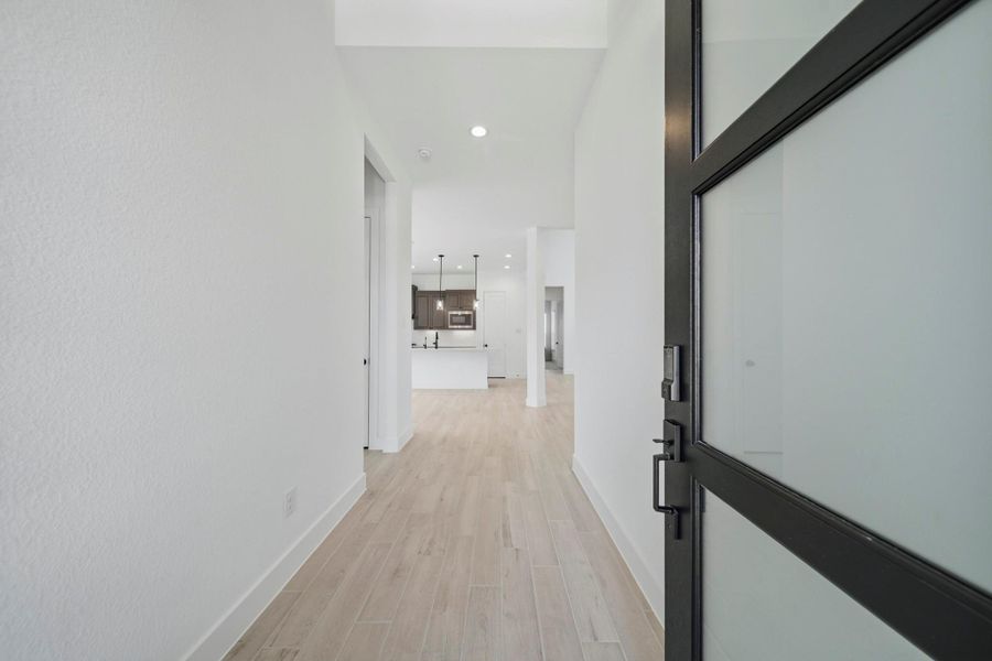 Walking in, you find a bright entryway with high ceilings and beautiful light wood like flooring that continues throughout the first floor in the main living areas making it easy to clean and maintain.