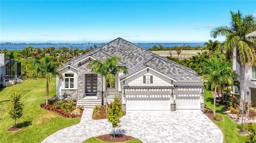 Front exterior of a new home in Legends Bay, Bradenton, FL, highlighting curb appeal (Image 25). Front exterior of a new home in Legends Bay, Bradenton, FL, highlighting curb appeal (Image 25).
