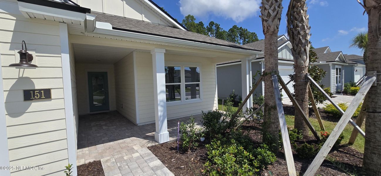 Exterior details and patio area of a home in Sawmill Branch Express, Palm Coast (Image 1).