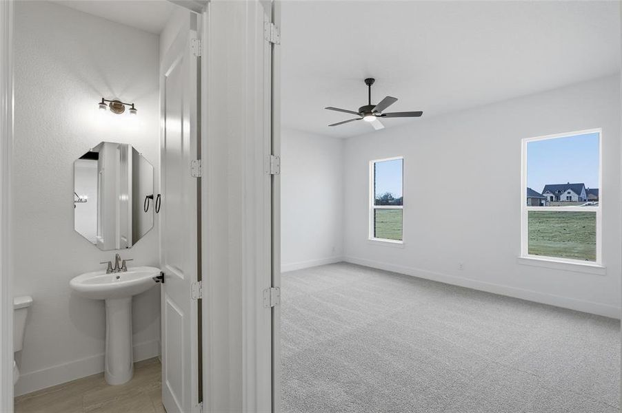 Half bath with toilet and ceiling fan