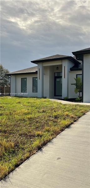 Front exterior of a new home in , Lehigh Acres, FL, highlighting curb appeal (Image 22). Front exterior of a new home in , Lehigh Acres, FL, highlighting curb appeal (Image 22).