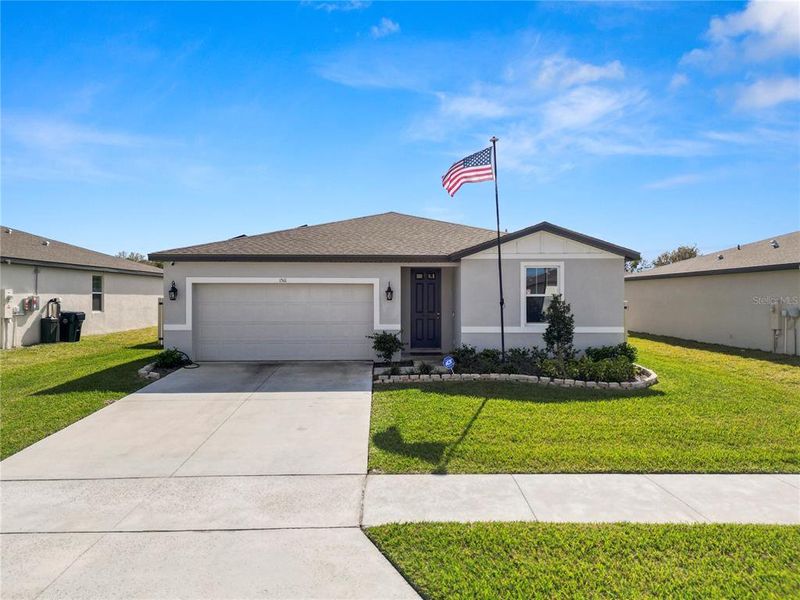 Front exterior of a new home in The Reserve at Van Oaks, Auburndale, FL, highlighting curb appeal (Image 2). Front exterior of a new home in The Reserve at Van Oaks, Auburndale, FL, highlighting curb appeal (Image 2).