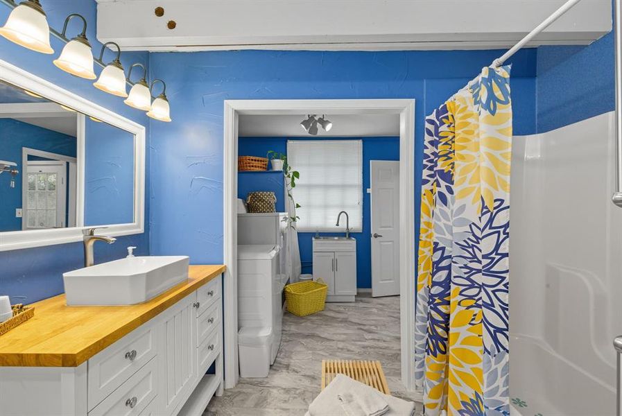 Full bathroom with vanity and a shower with curtain Full bathroom with vanity and a shower with curtain