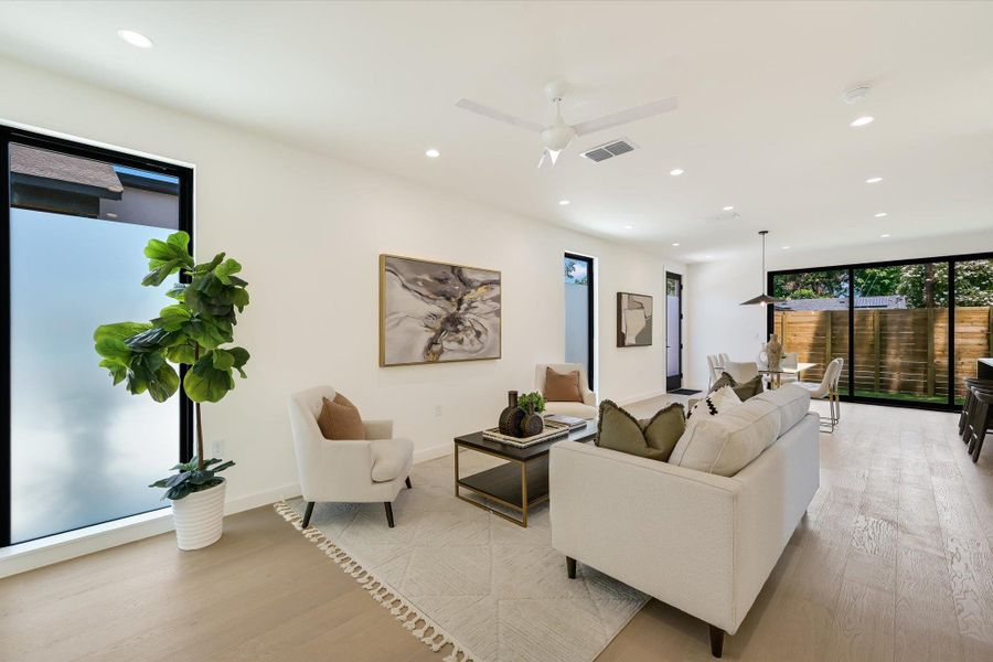 Living room featuring recessed lighting, light wood-style flooring, and ceiling fan
