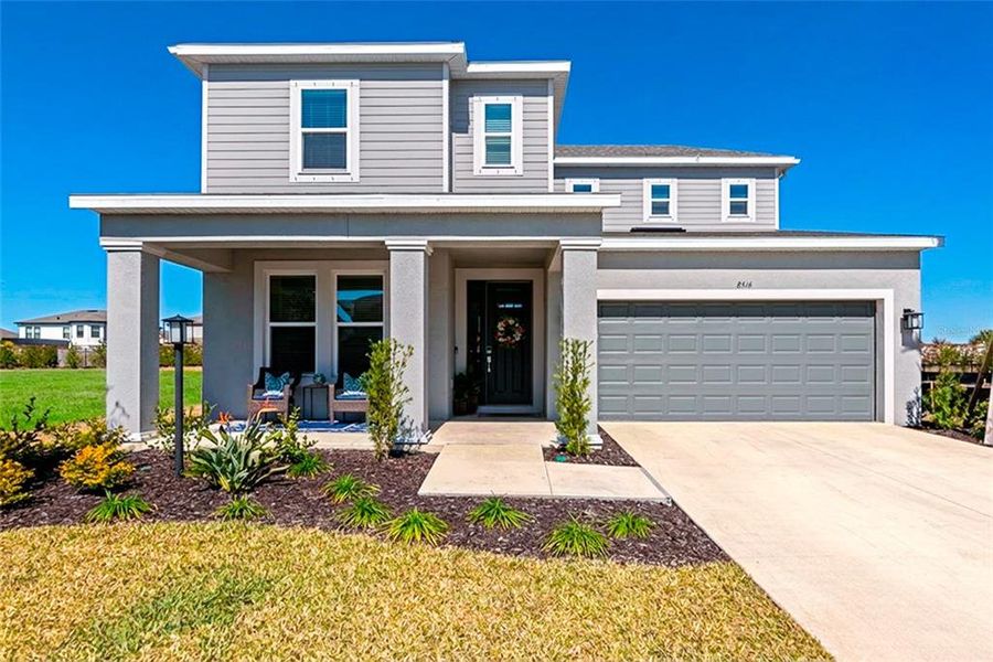 Front exterior of a new home in Skye Ranch Community Group Page, Sarasota, FL, highlighting curb appeal (Image 24).