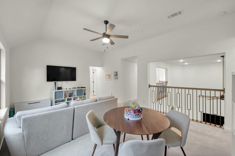 The upstairs game room offers additional living space perfect for movie nights or play.