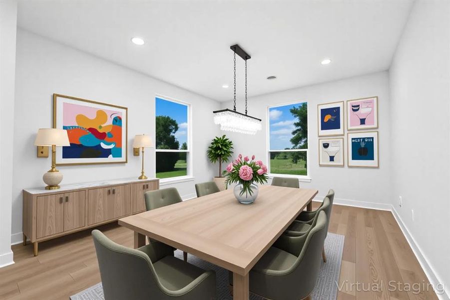 Dining area featuring light wood-style flooring, healthy amount of natural light, and recessed lighting