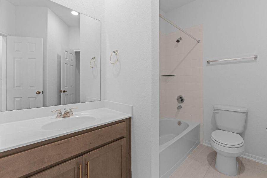 The secondary bath features tile flooring, white cabinetry and light countertops and a shower/tub combo. Perfect for accommodating any visiting family and friends. The secondary bath features tile flooring, white cabinetry and light countertops and a shower/tub combo. Perfect for accommodating any visiting family and friends.