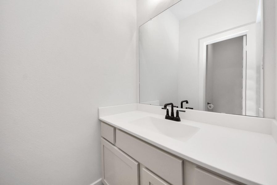 Jack-and-Jill vanity featuring modern fixtures and plenty of counter space, conveniently shared between the upstairs bedrooms.