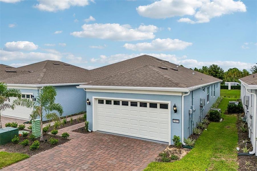 Front exterior of a new home in Del Webb Oasis, Winter Garden, FL, highlighting curb appeal (Image 22). Front exterior of a new home in Del Webb Oasis, Winter Garden, FL, highlighting curb appeal (Image 22).