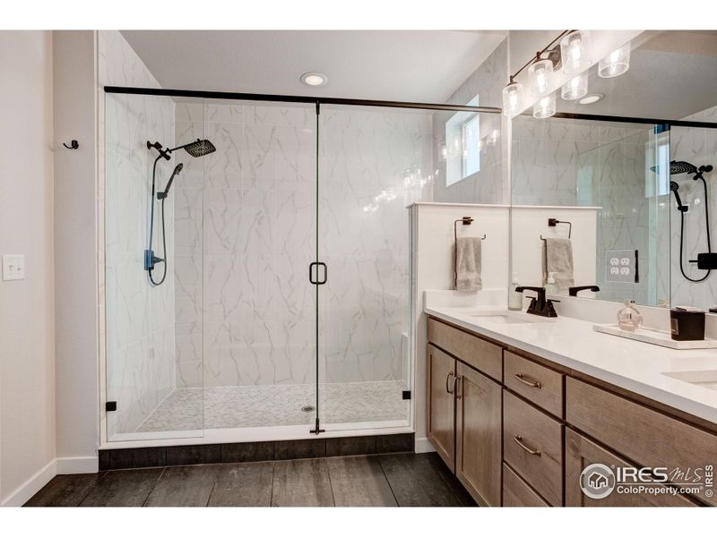 The DELUXE Primary ensuite dual sinks and Huge shower with dual shower heads and seat.